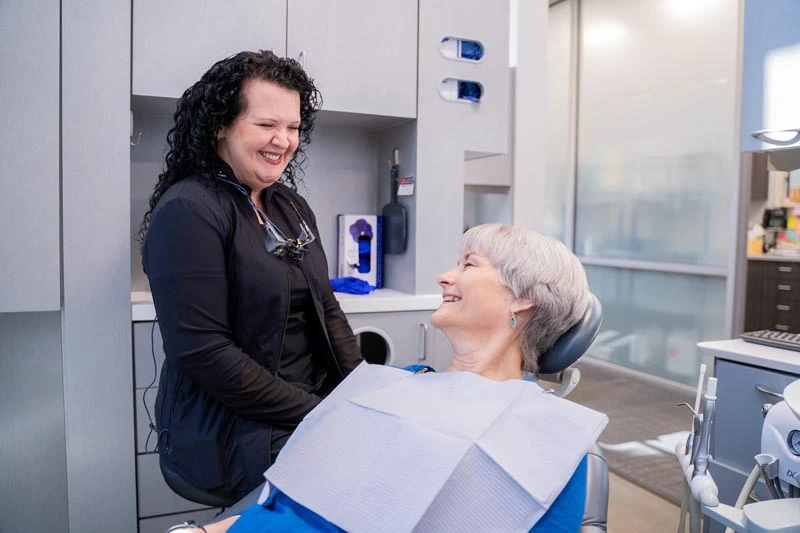 Patient in the exam chair speaking with the staff at Contemporary Dental Arts in Tulsa OK about dental veneer options. 
