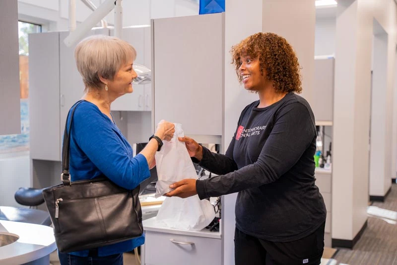 The friendly staff at Contemporary Dental Arts in Tulsa, OK speaking with a patient. 
