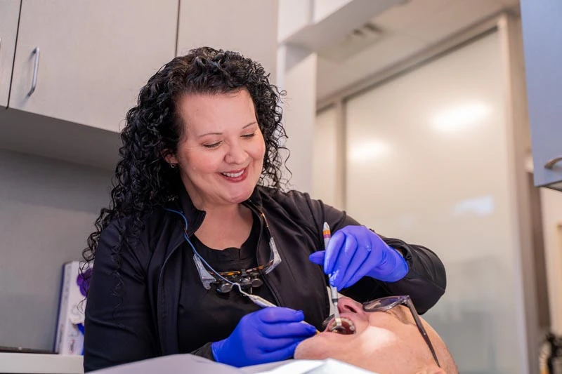 A senior patient speaking with the staff at Contemporary Dental Arts in Tulsa, OK.