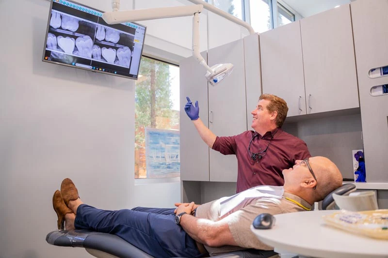 A senior patient speaking with the staff at Contemporary Dental Arts in Tulsa, OK about dental sedation options.