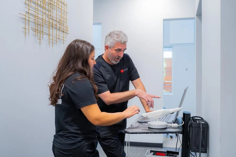 A senior patient speaking with the staff at Contemporary Dental Arts in Tulsa, OK.