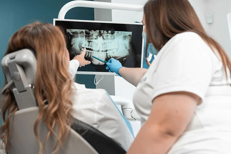 dentist and patient reviewing dental x-rays together